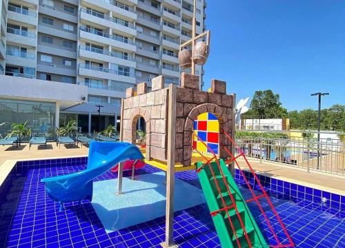 a playground with a castle and a slide at Recanto do Bosque Caldas Novas Temporada in Caldas Novas