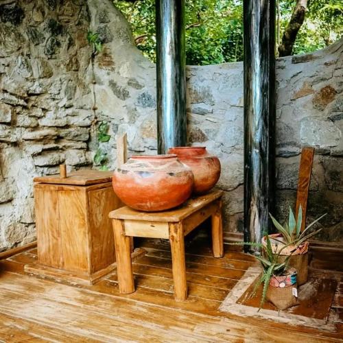 two large clay vases sitting on a table at Butterfly Space- A Non-Profit Eco-Lodge in Nkhata Bay