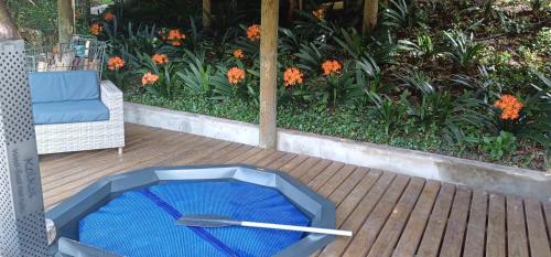 a blue dog bowl sitting on a wooden deck at Assegai Rest in Robertson