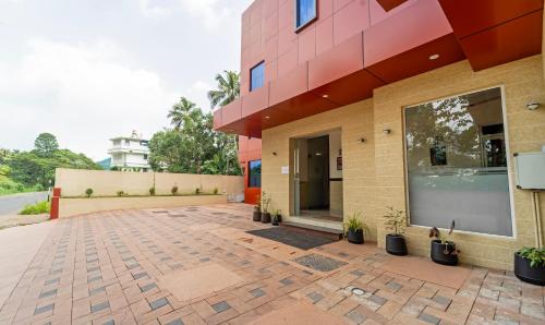 a building with a brick courtyard in front of it at Treebo Thoduvas Star Plaza Cochin Airport in Nedumbassery