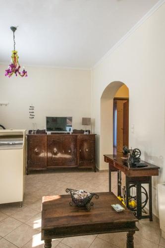 a living room with a table and a kitchen at Kaloudis Apartment in Kissamos