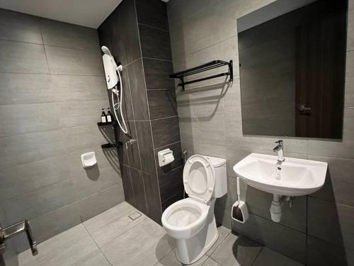 a bathroom with a toilet and a sink at The Luxe Suite, Sunway City with 2Bedroom and Netflix in Subang Jaya