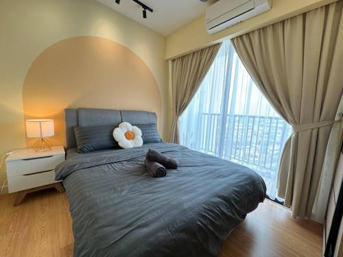 a bedroom with a bed with a teddy bear on it at The Luxe Suite, Sunway City with 2Bedroom and Netflix in Subang Jaya