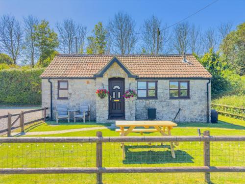 a small house with a picnic table in front of it at Cosy & Characterful, Seaside Cottage, Dog Friendly in Worle