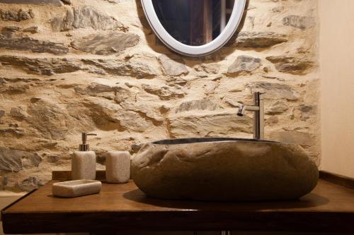 a bathroom with a stone sink and two towels at Il Nettare Agriturismo in Riomaggiore