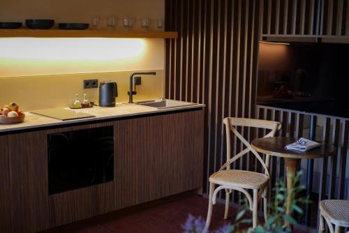 a kitchen with a sink and a table and chairs at ARVED Apartments in Lübeck