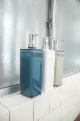 a counter with two paper towels and two faucets at 無料駐車場有り 新大阪駅まで1駅1分 Guest House 橘 東三国,最大12名,最寄り駅まで徒歩5分,2階建て貸切 in Osaka