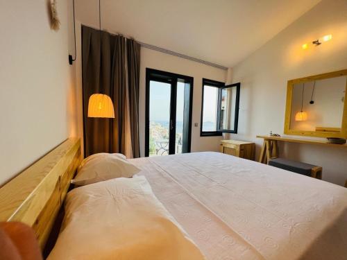 a bedroom with a large bed with a large window at The Bay View Boutique Hotel Kalkan in Kas