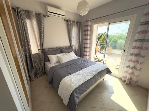 a bedroom with a bed and a large window at emiwadar Agadir Lunja Village in Agadir