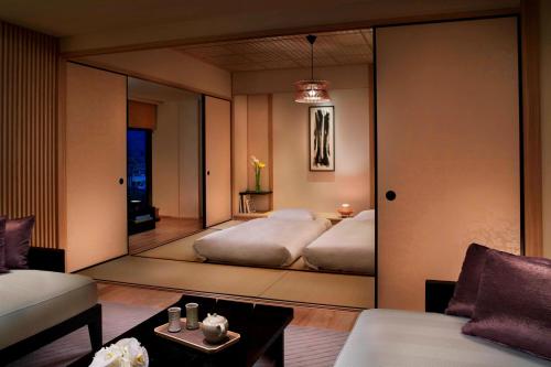 a bedroom with a mirror in the middle of it at The Ritz-Carlton Kyoto in Kyoto