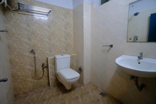 a bathroom with a toilet and a sink at Blue City Palace - Near Chennai Airport in Chennai
