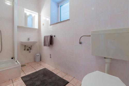 a bathroom with a toilet and a sink at AKELAVA in Crikvenica