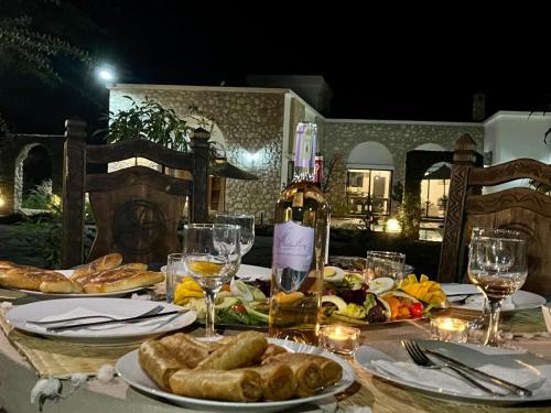 a table with plates of food and glasses of wine at Villa Serinie in Essaouira