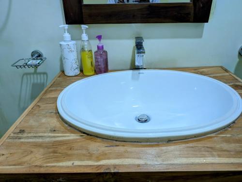a white sink on a wooden counter in a bathroom at Costels Weligama in Weligama