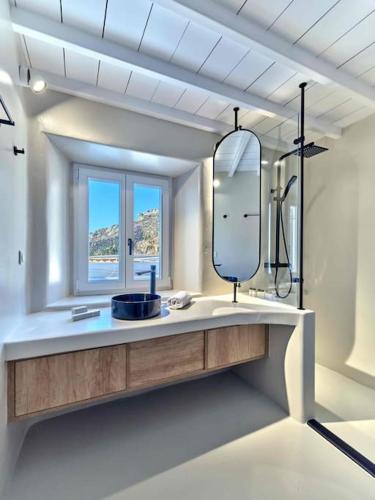 a bathroom with a sink and a mirror at Villa Maera 3 in Kalo Livadi