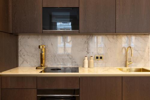 a kitchen with a sink and a counter top at josef's home I Superior Suite I Quiet & Central in Vienna