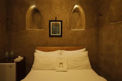 Postel nebo postele na pokoji v ubytování بيت الصباح نزل وكافيه Bait AlSabah Heritage Inn & Cafe