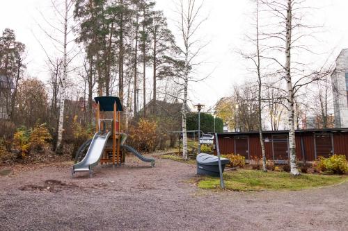 a playground with a slide in a park at Romantic Sauna Retreat Near Sello and Nature Perfect in Espoo
