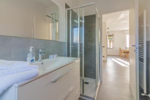 a bathroom with a sink and a glass shower at Sweet Caroline in Lierna