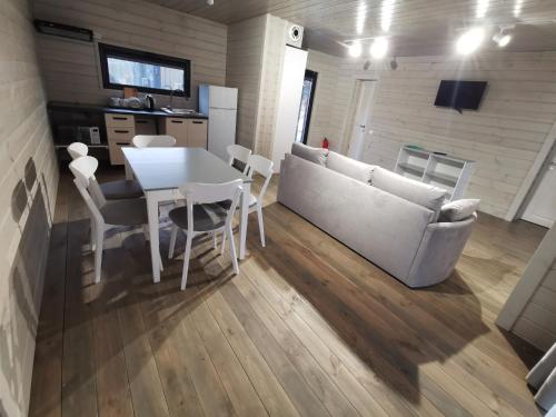 a living room with a table and a couch at Екосадиба Водограй in Kvasy