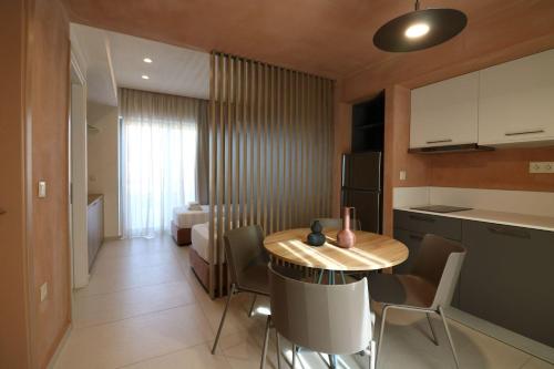 a kitchen and dining room with a table and chairs at Philoxenia Apartments in Panormos Rethymno