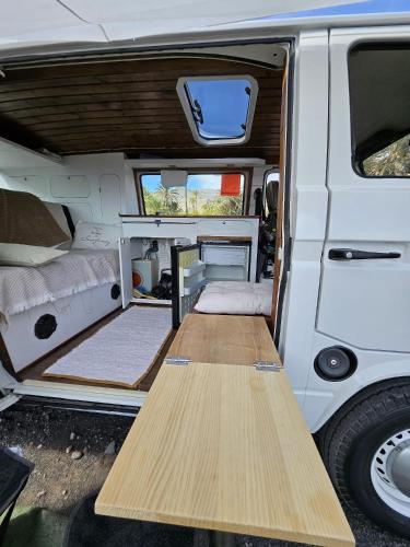 an open door of a white van with a table inside at Furgot3 in Agulo