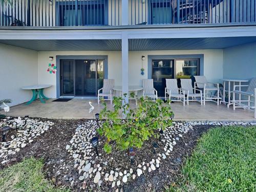 una casa con un patio con sillas y una mesa en Sea Winds 52, en St. Augustine