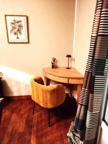 a room with a wooden table and a chair and a table and a tableearcher at LA TANIÈRE in Gueures
