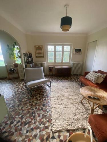 - un salon avec un canapé, des chaises et un tapis dans l'établissement Détente en Bord de Seine - Collection Idylliq, à Vétheuil