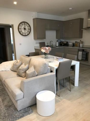 a living room with a couch and a table at Elegant Epsom Family in Epsom
