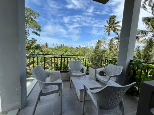 a patio with a table and chairs on a balcony at Coastal Hideaway in Midigama