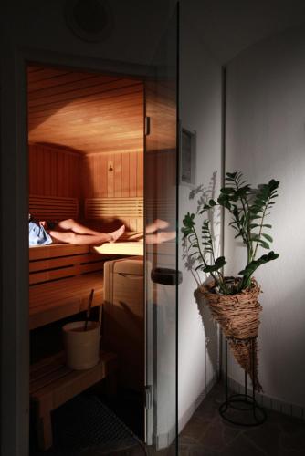 a room with a bed with a plant in it at dr'Berghof in Damuls