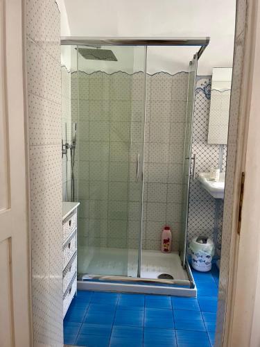 a shower with a glass door in a bathroom at Casa Cardi in Sperlonga