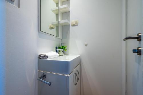a bathroom with a sink and a mirror at Villa Almond in Nin