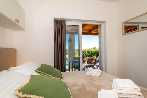 a bedroom with a bed with a view of a patio at Villa Almond in Nin