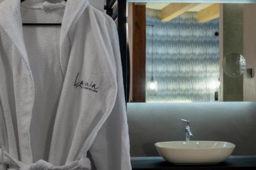 a bathroom with a white shower curtain and a sink at Ladinia Dolomites View - Adults Only in Pozza di Fassa