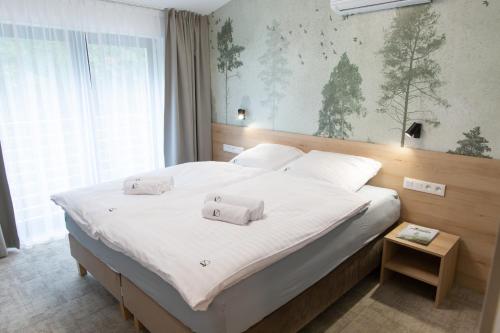 Ένα ή περισσότερα κρεβάτια σε δωμάτιο στο Drawskie Apartamenty