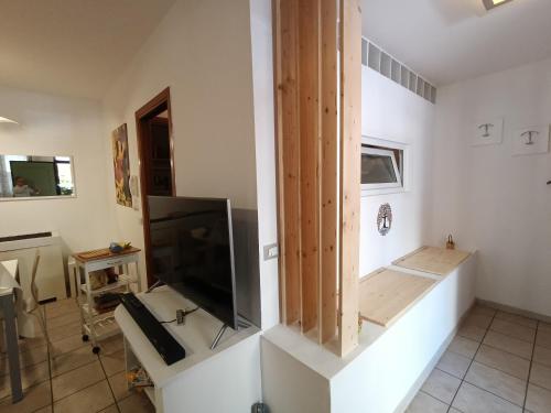a living room with a flat screen tv on a wall at Borgo Bello apartment in Perugia