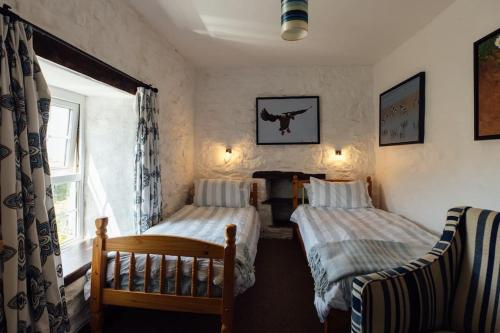 a bedroom with two beds and a window at Trefrane Lodge in HAW