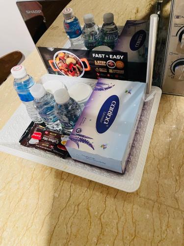 an open refrigerator with water bottles and a box at Crystal Studio Apartment KBCP in Kota Bharu