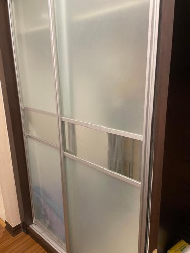 a refrigerator with empty shelves in a room at Crystal Studio Apartment KBCP in Kota Bharu