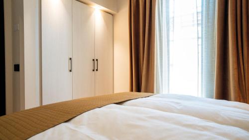 a bedroom with a white bed and a window at Relais Santa Lucia - Appartamenti Superior e Deluxe in Vicenza