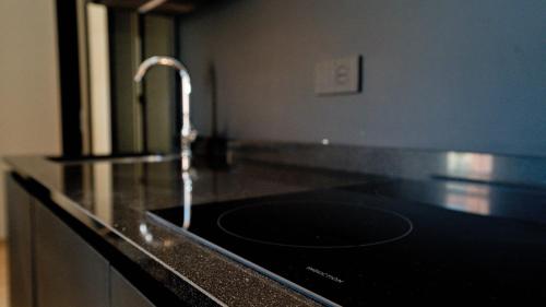 a kitchen counter with a sink with a faucet at Relais Santa Lucia - Appartamenti Superior e Deluxe in Vicenza