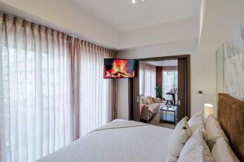 a bedroom with a bed and a large window at Chic Centric 1BR Apt, King Bed in Los Prados