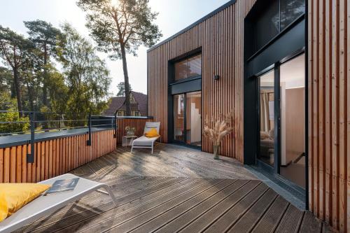 a deck with a bed and a couch on a house at Haus 1 - ELF AM SEE in Templin