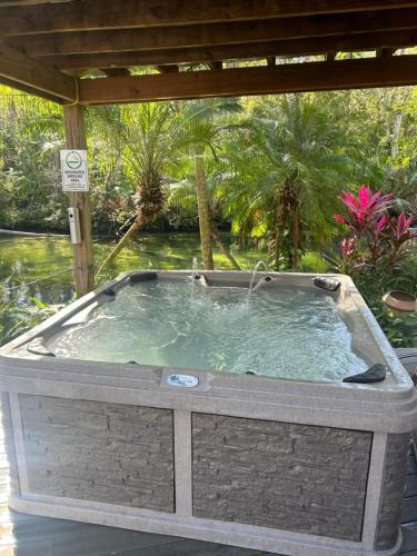 a jacuzzi tub sitting on a patio at Main River Retreat hot tub, canoe with trolling motor in Spring Hill