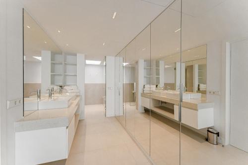 a bathroom with two sinks and two mirrors at SVB Aquasuites Luxury Penthouse - A02 in Santiago del Teide