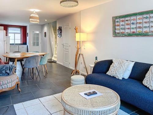 un salon avec un canapé bleu et une table dans l'établissement Wambrechies centre maison 3 chb, à Wambrechies