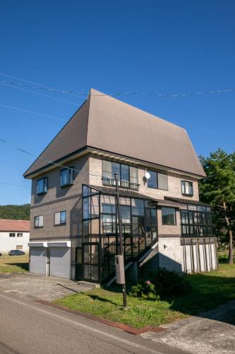 a large building with a roof and windows at Villa Olive Myoko in Myoko