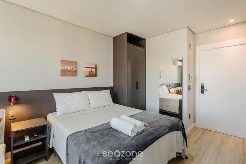 a bedroom with a large white bed in a room at TCO - Apartamentos no Centro Histórico Porto Alegre/RS in Porto Alegre